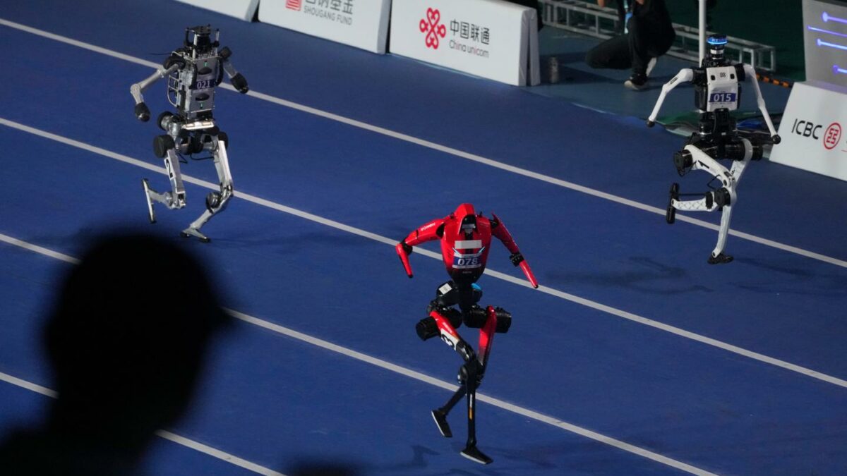 Robots compete in the 100m race during the opening ceremony of the World Humanoid Robot Games in Beijing, Saturday, Aug. 22, 2026.