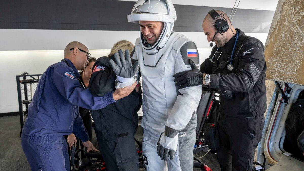 Roscosmos cosmonaut Andrey Fedyaev is helped out of the SpaceX recovery ship.