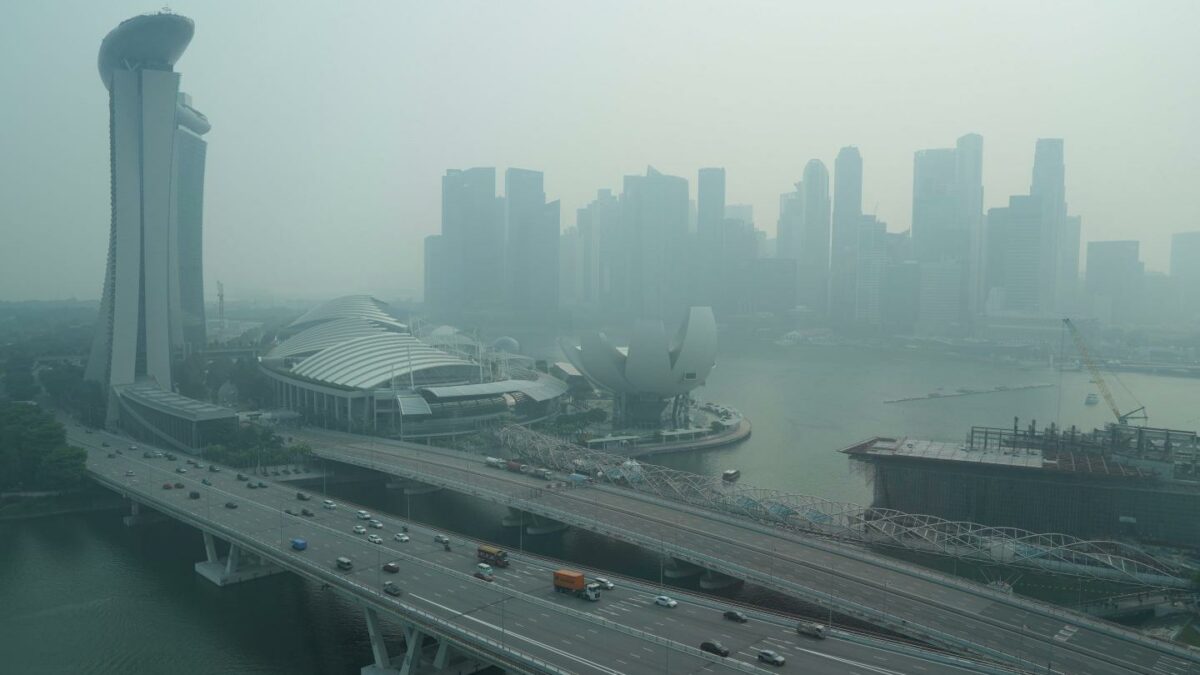 A thick haze obscures the skyline behind the Central Business District area in Singapore.