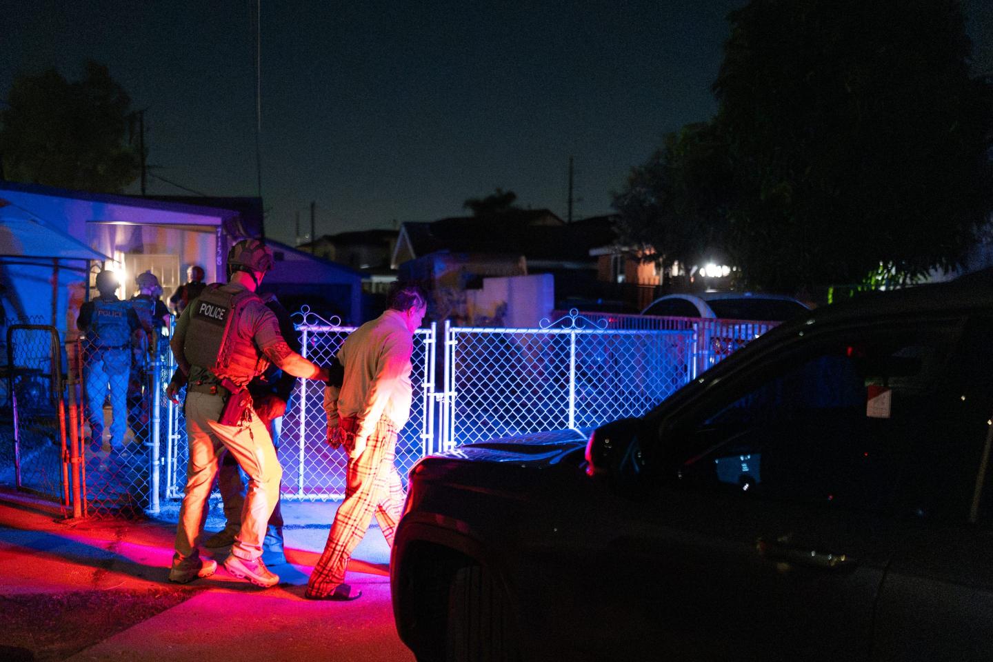 Homeland Security Investigations task force officers arrest a suspect accused of illegally registering to vote during a federal operation in Commerce.