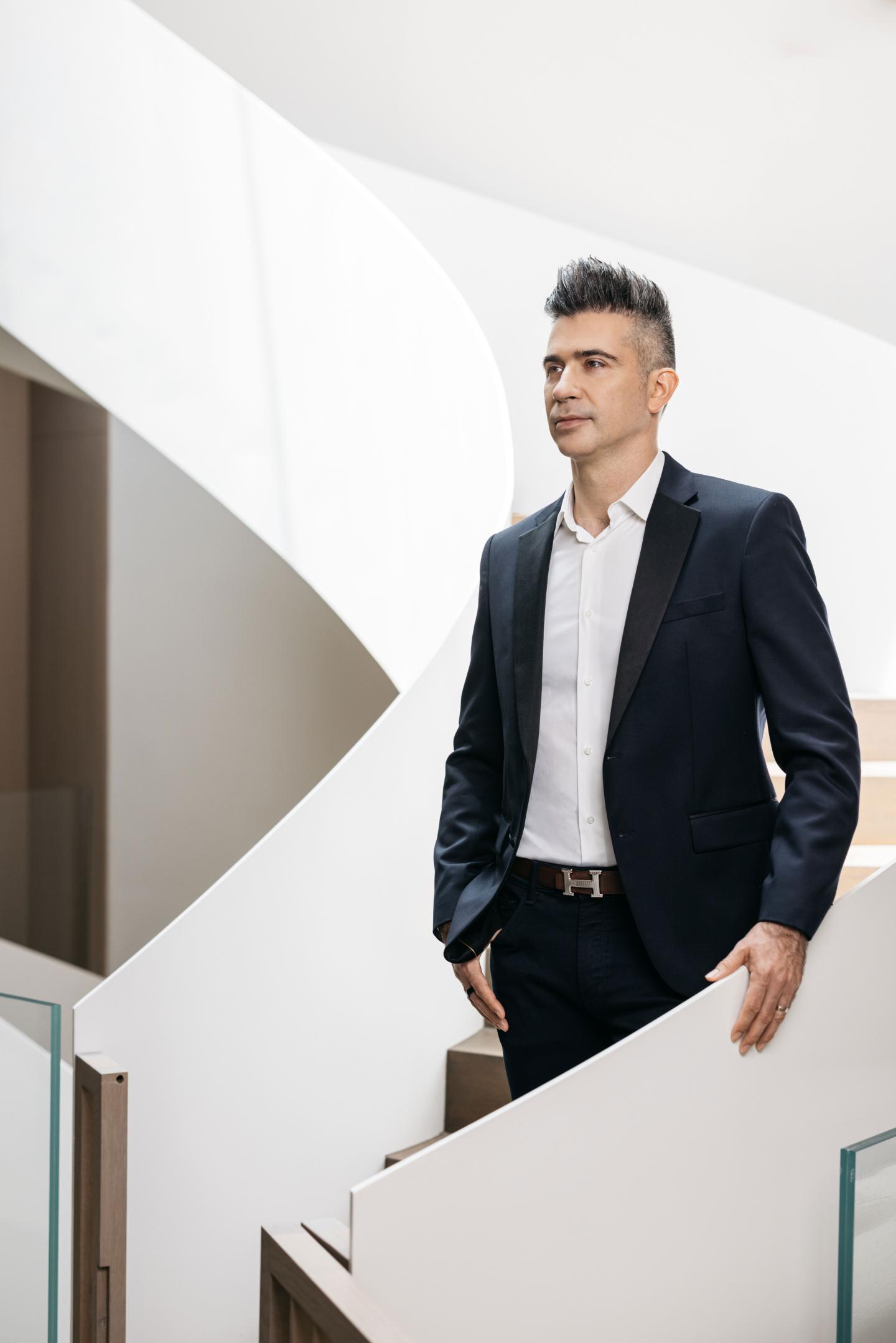 avishag-shaar-yashuv-2 Yevgeny Dibrov wears a suit and stands on a white modern staircase
