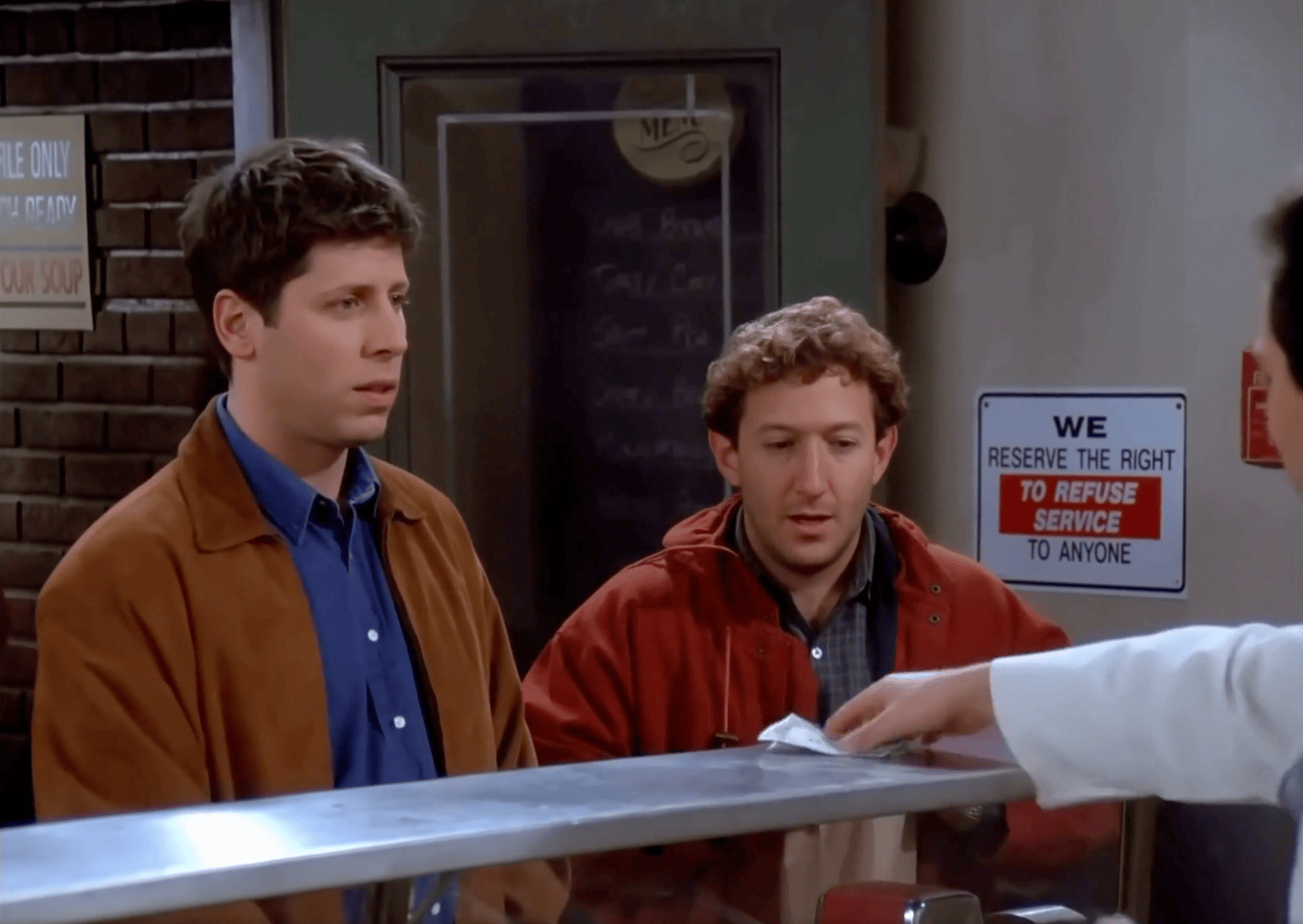 fortune-tech-parting-shot-2026-10-05 A still from an AI-generated video superimposing OpenAI CEO Sam Altman and Meta CEO Mark Zuckerberg on a scene from the TV series Seinfeld.