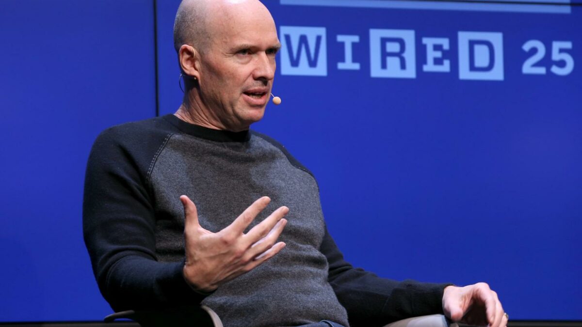 Bald man gesturing while talking