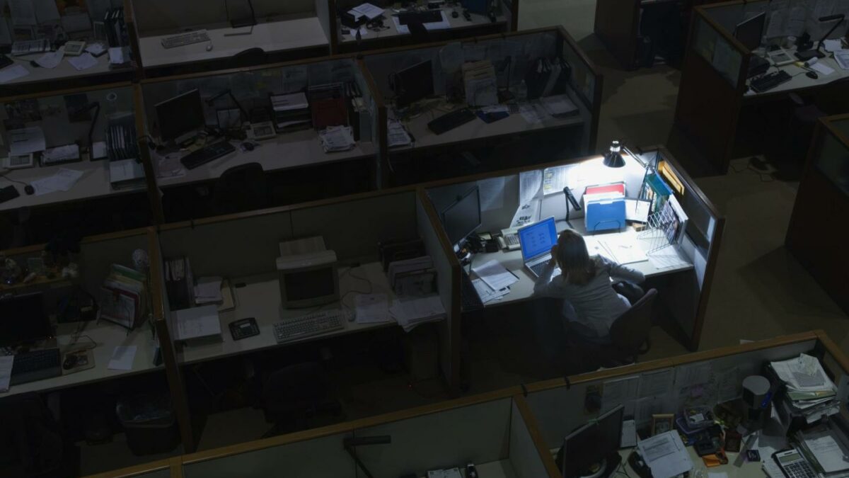 Woman working late at night in office.