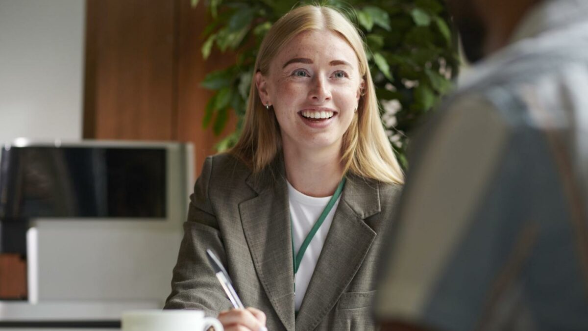 young woman speaking to a client