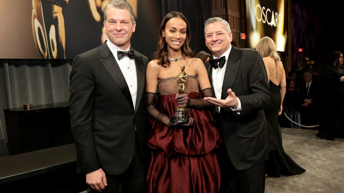 Netflix co-CEOs Greg Peters (left) and Ted Sarandos (right) with actor Zoe SaldaƱa on March 02, 2025 in Hollywood, California. (Photo: Monica Schipper/Getty Images)