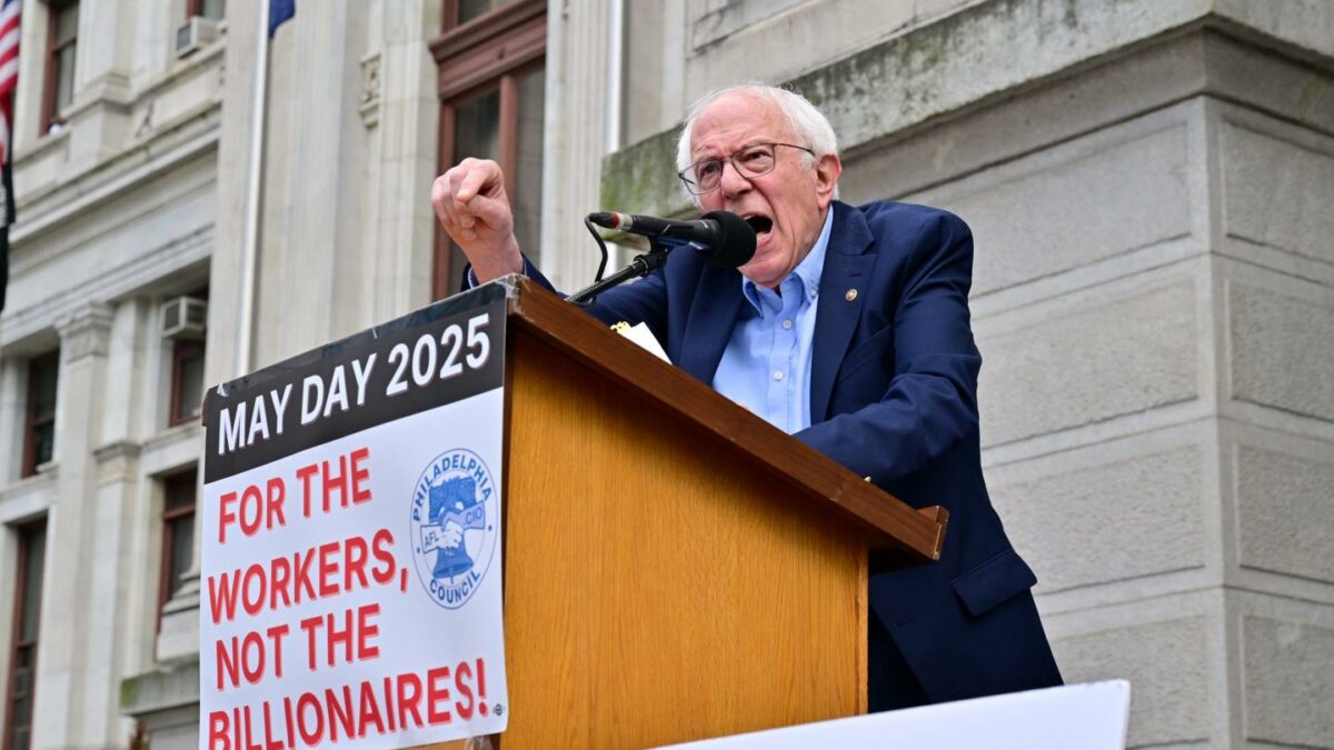 Sen. Bernie Sanders speaks at a 2025 workers’ rally. The longtime labor advocate is again pushing for a 32-hour workweek as AI boosts productivity.