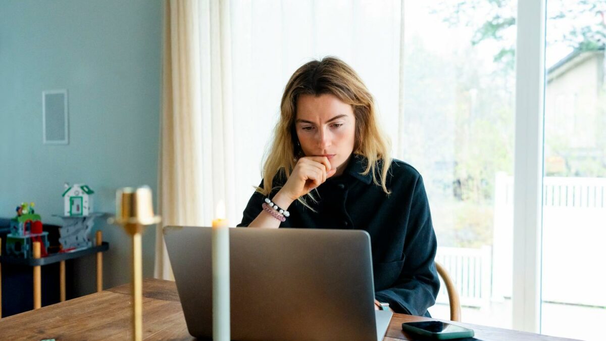 Woman at home looking at her laptop screen
