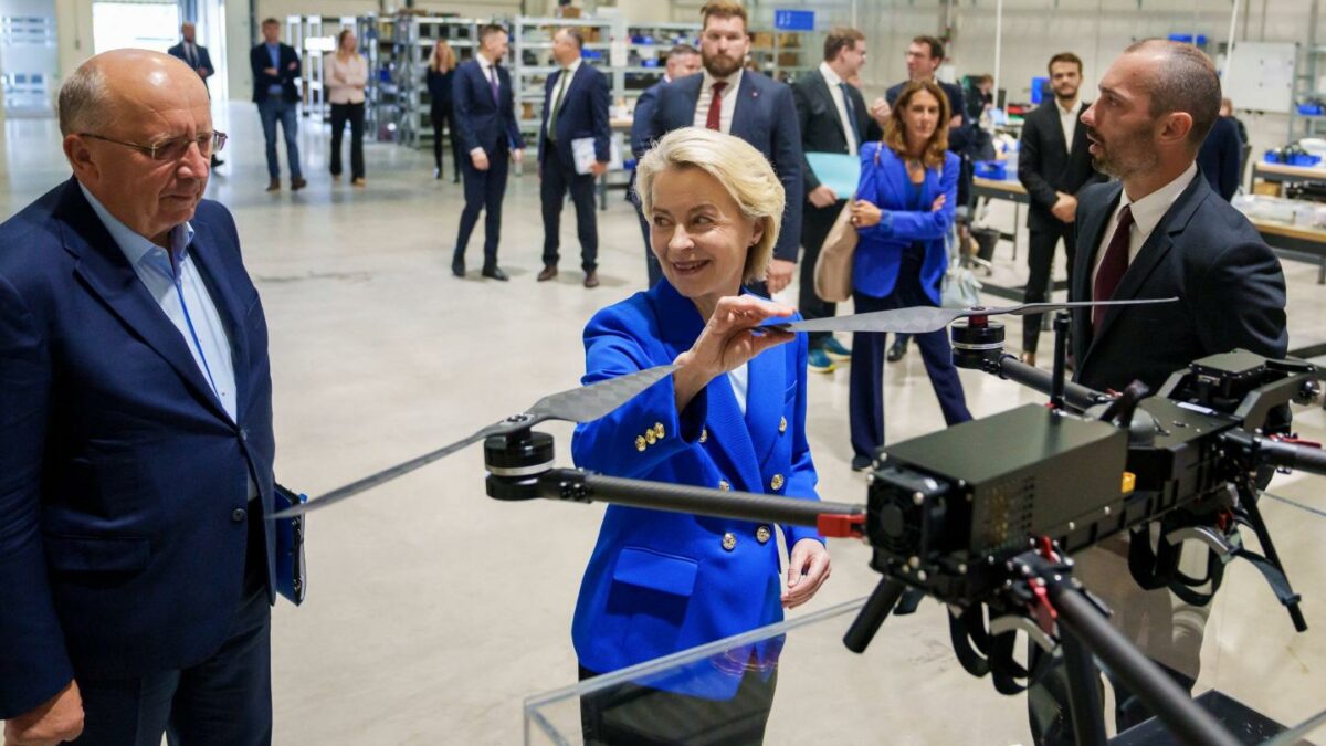 European Commission President Ursula von der Leyen (C) looks at a drone as she stands next to European Commissioner for Defence and Space Andrius Kubilius (L) and Origin Robotics co-founder and Chief Technology Officer (CTO) Agris Kipurs (R).
