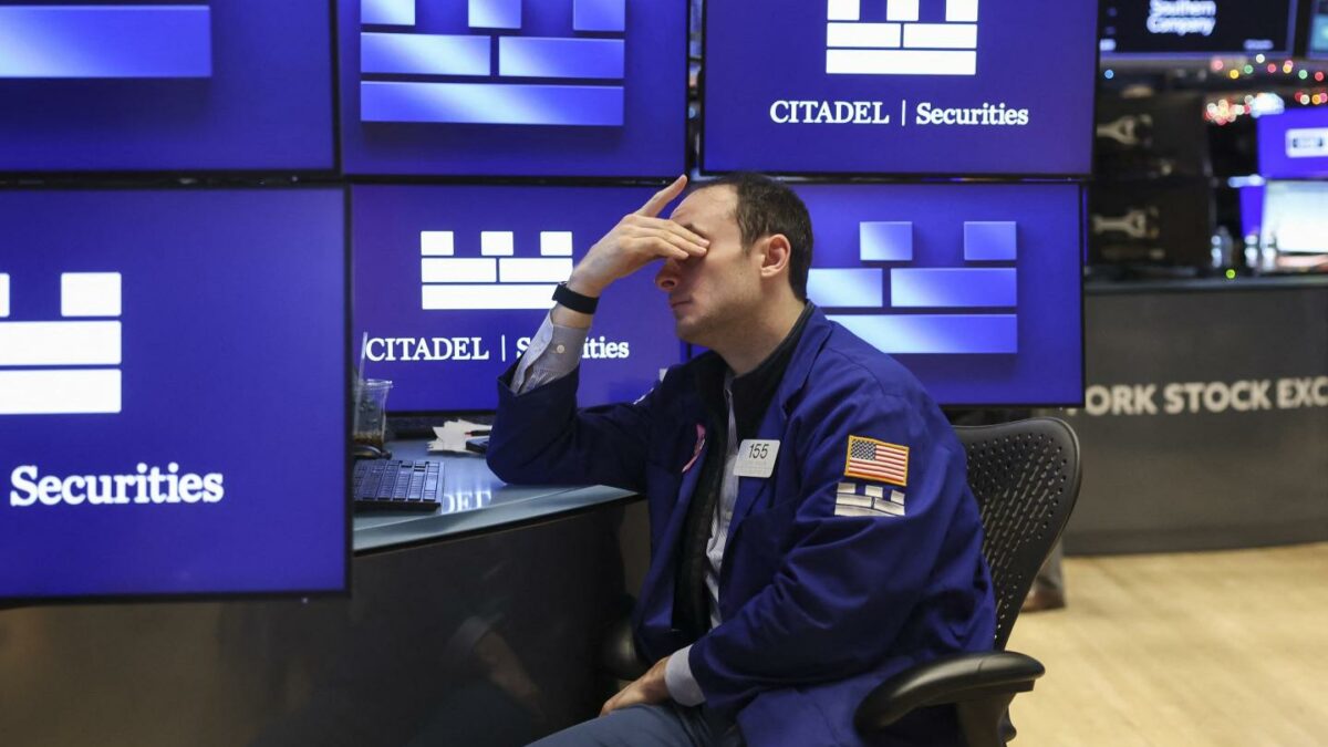 A trader works on the floor of the New York Stock Exchange after the opening bell on January 2, 2026.