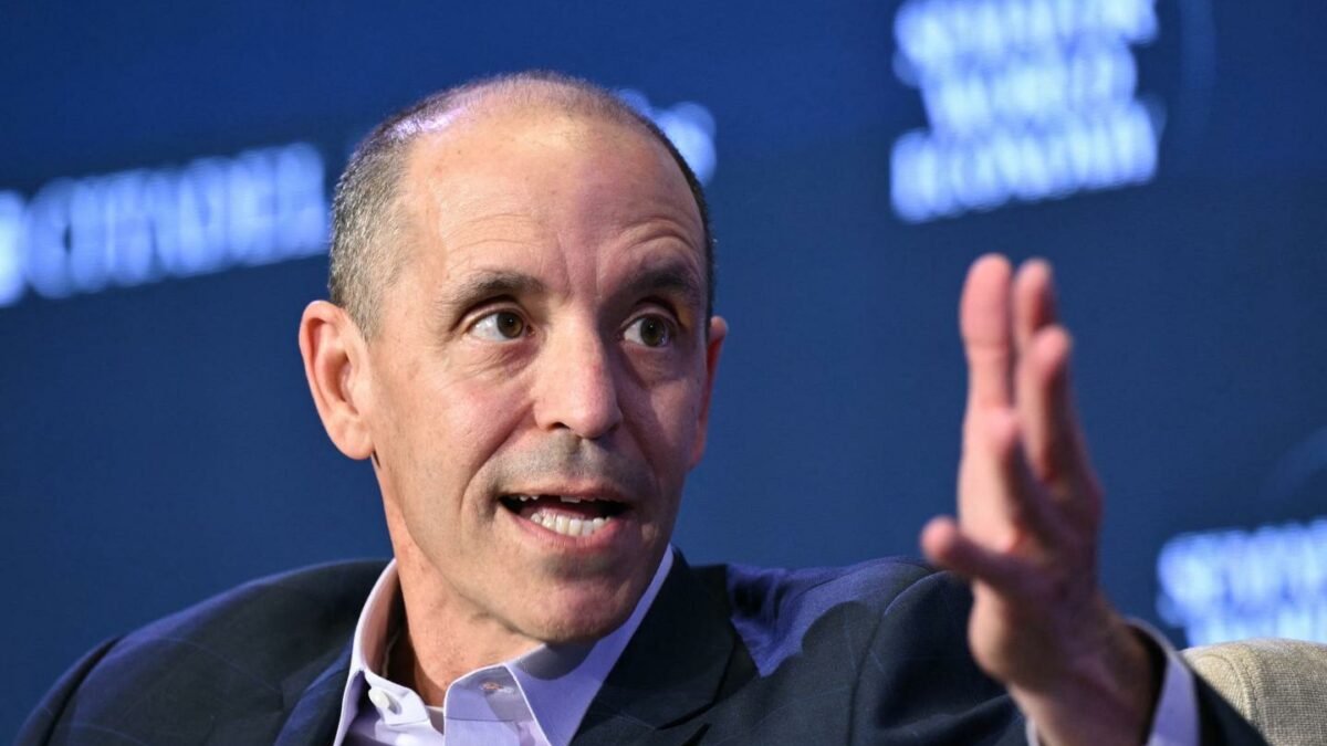 Chris LeHane, OpenAi's vice president of global policy, gesturing with one hand outstretched while speaking on stage at a conference.