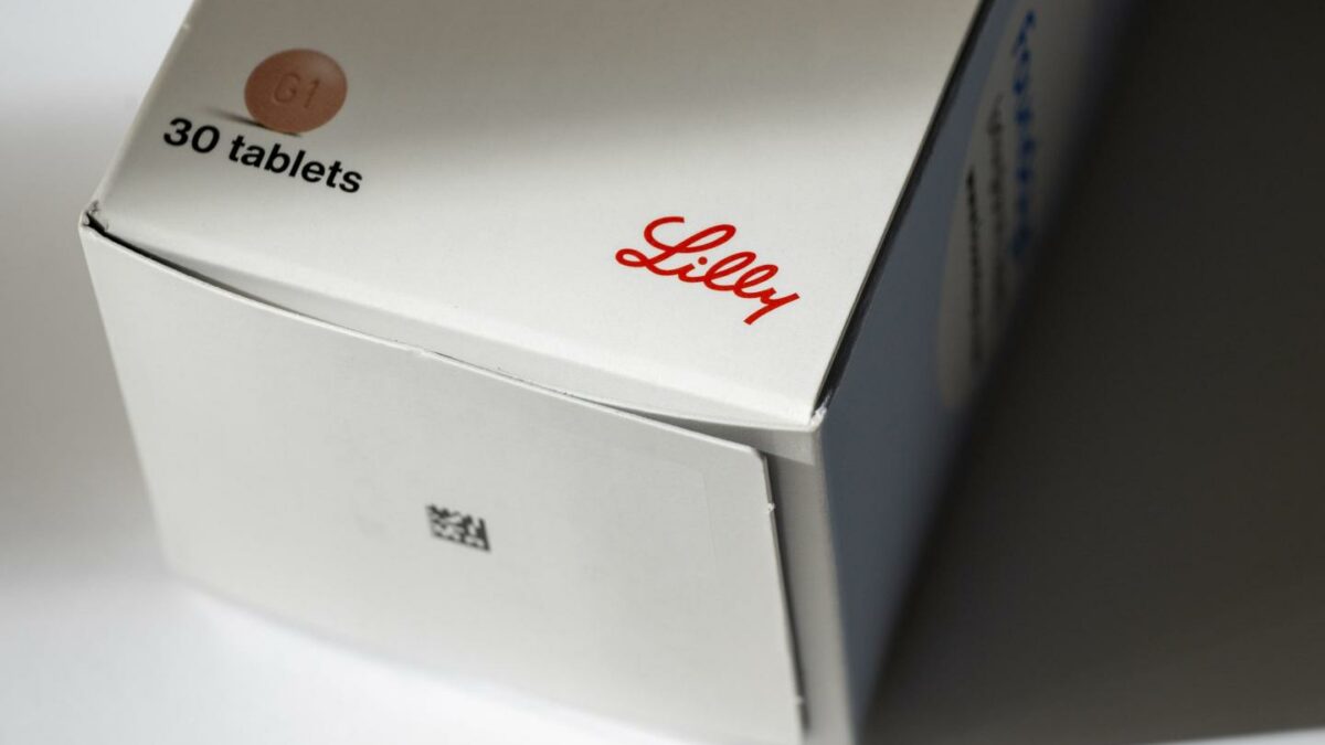photo illustration of the Eli Lilly logo on a box of the new Foundayo weight loss oral pill.