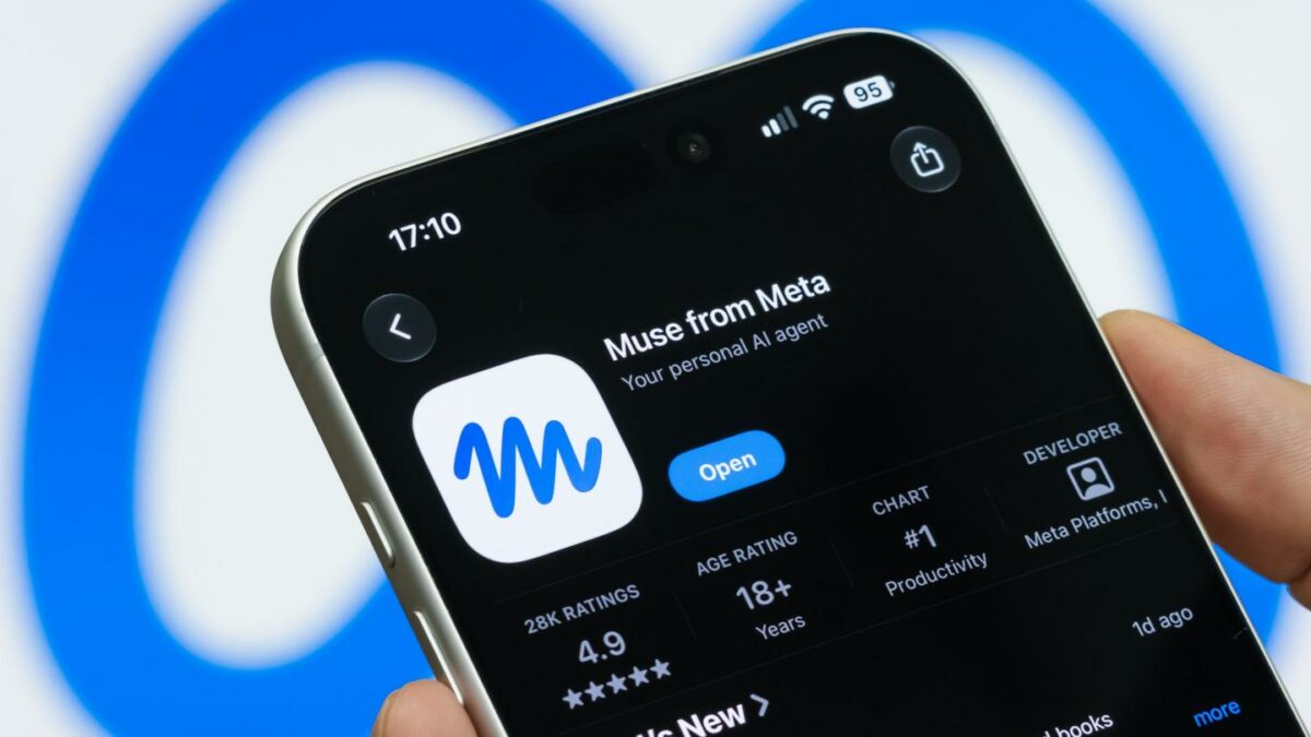 In this photo illustration, a hand holds a smartphone displaying the App Store listing for Meta's Muse AI assistant in front of the Meta logo on a computer screen on September 22, 2026.