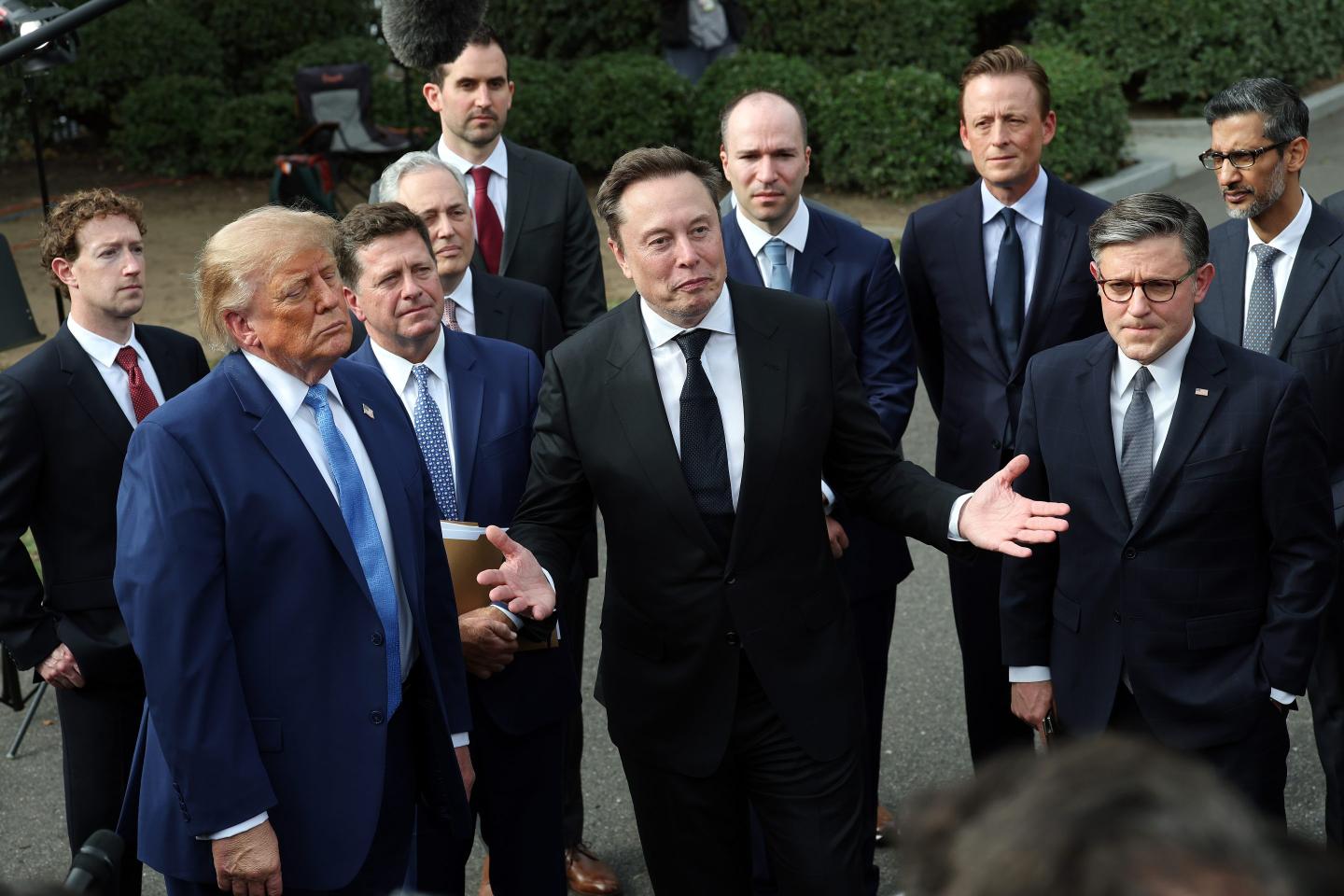 Trump stands with tech CEOs.