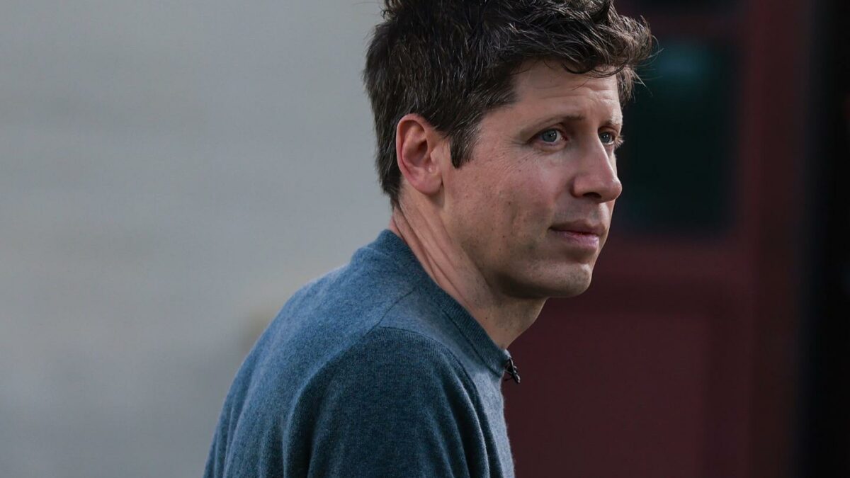 Sam Altman wearing blue sweater looks to hsi right.