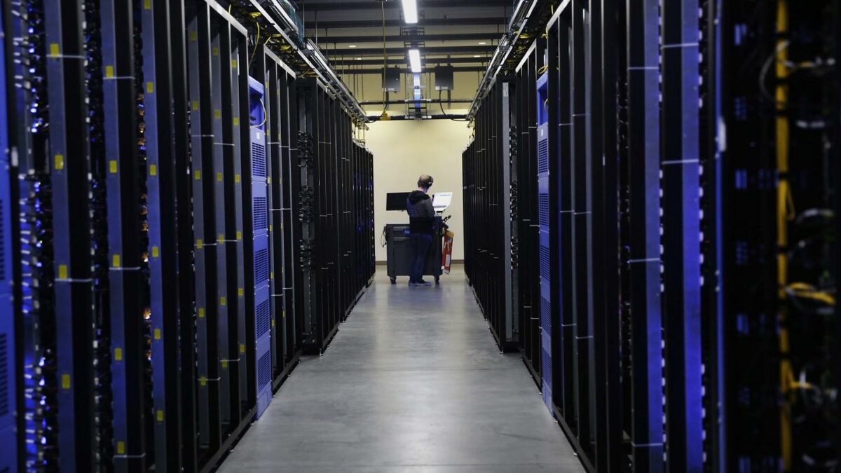 An employee fixes part of a web server inside the Facebook Inc. Prineville Data Center in Prineville, Oregon, U.S.