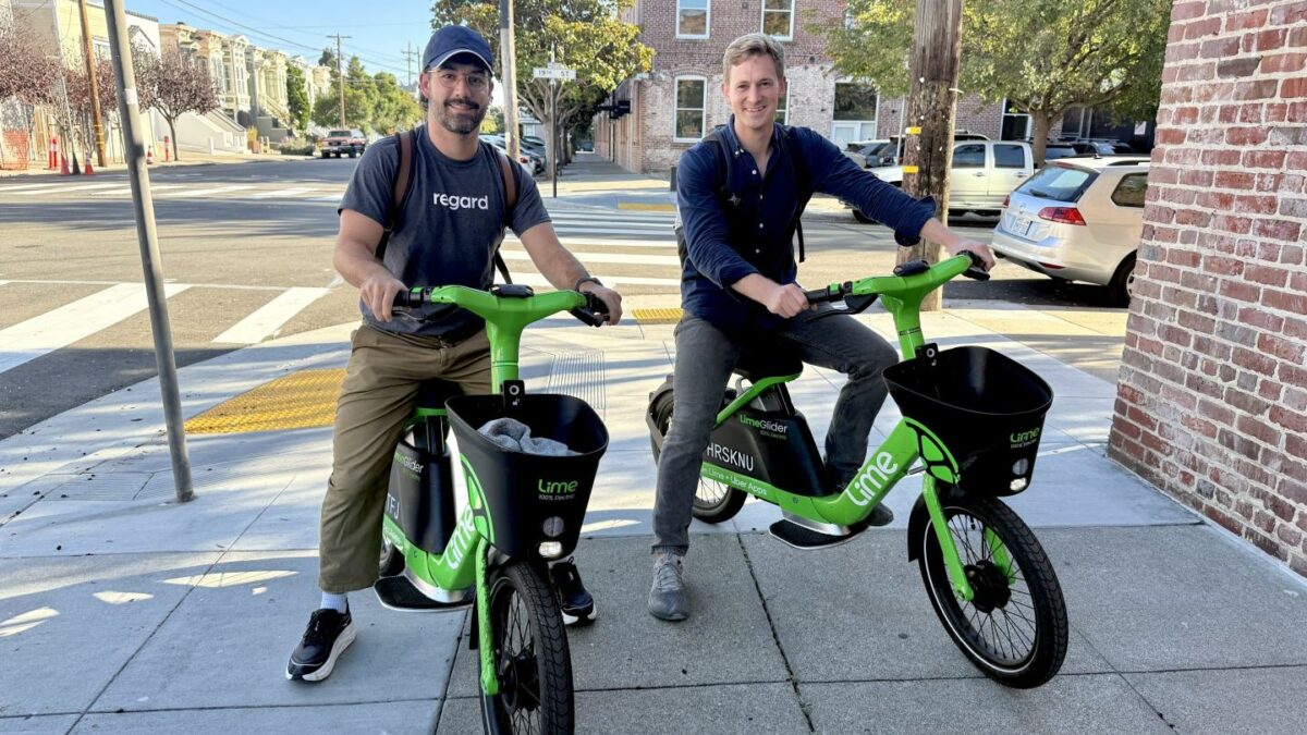 Cofounders Nate Wilson and Eli Ben-Johnson sit on robobikes.