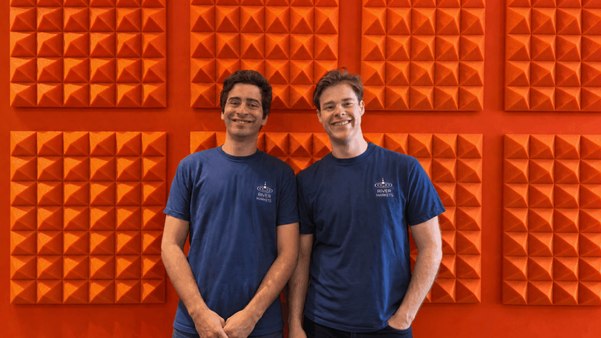 Antonin Parrot (left) and Oscar Levy (right) are seen smiling against an orange wall.