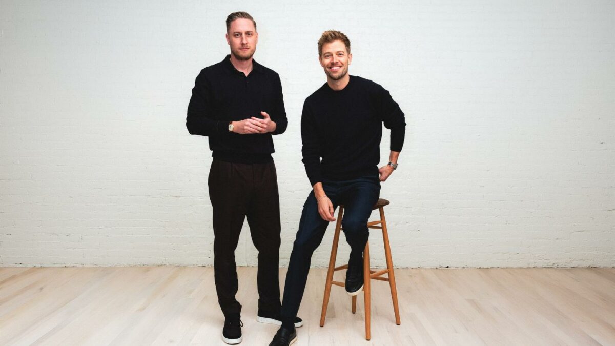 Public cofounder Leif Abraham (left) stands smiling at camera while Jannick Malling (right) does the same while sitting on a high stool.