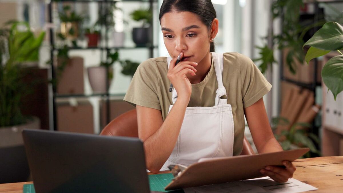 A person in a florist shop looking at a computer.